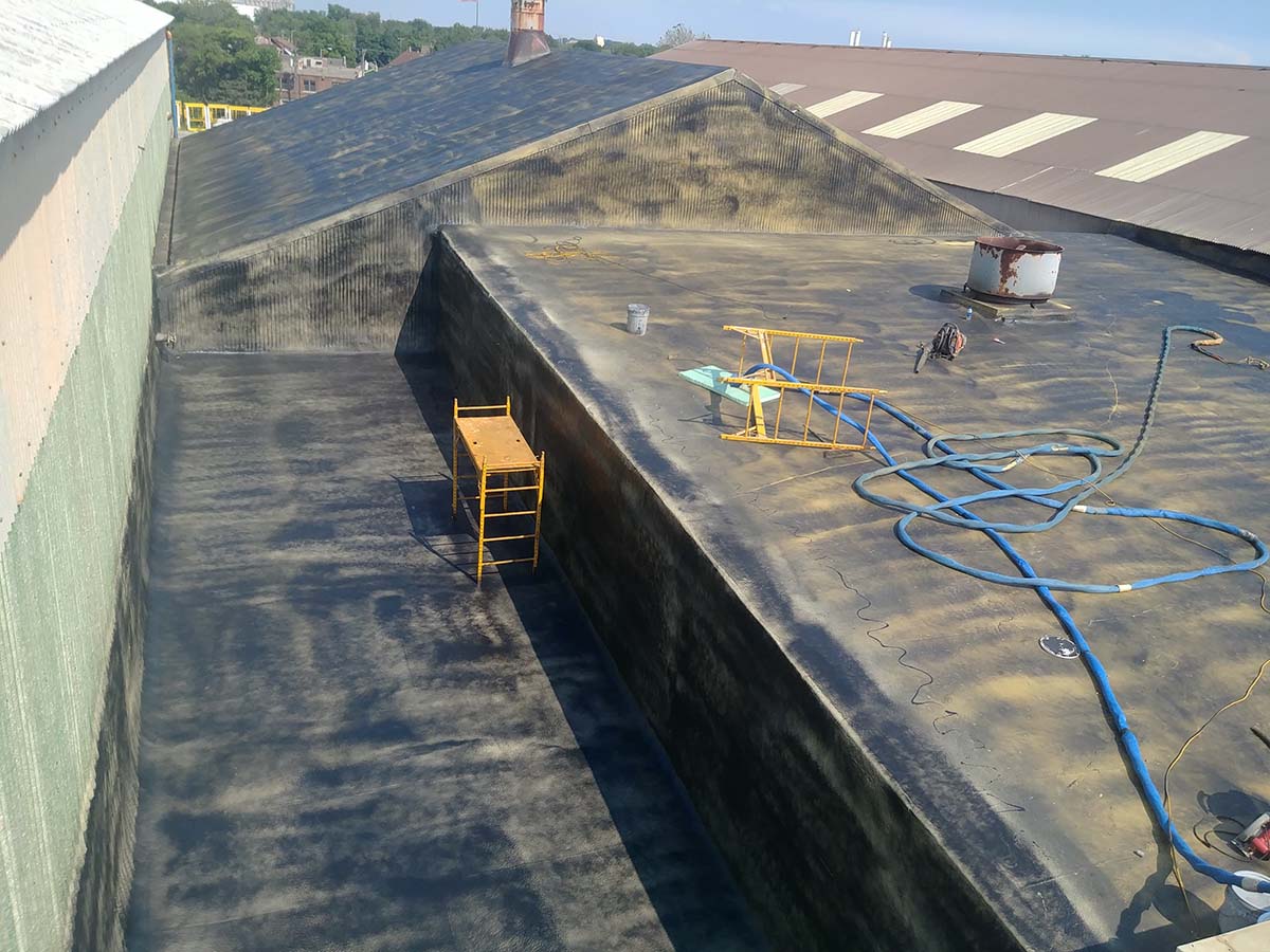 Seamless spray-applied membrane covering horizontal surfaces and containment walls