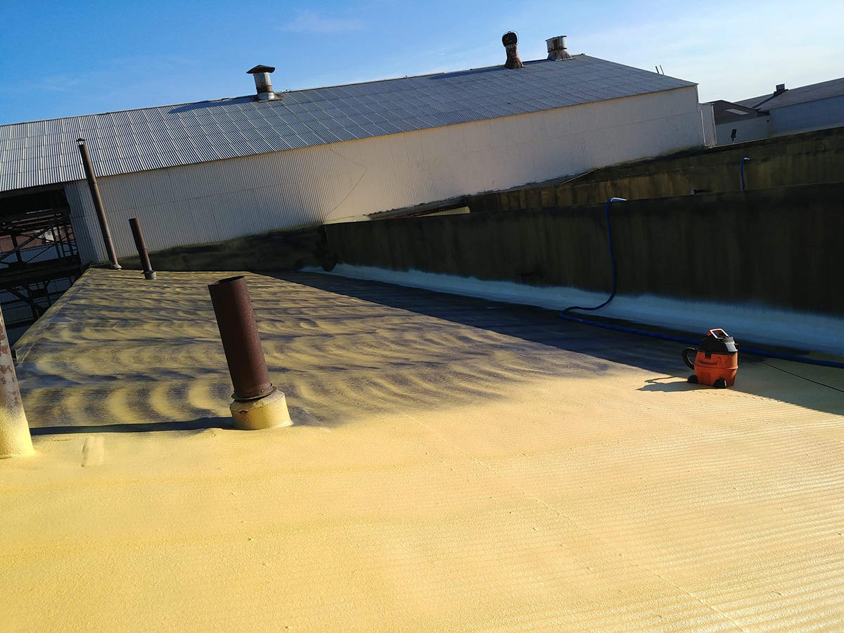 Fresh SPF roof application on an industrial building in Grand Blanc Michigan