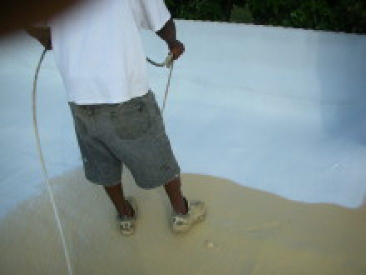 Applicator spraying seamless protective coating by hand